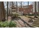 A brick home with a screened-in porch in a wooded backyard and landscape at 4808 Clubview Ct, Fuquay Varina, NC 27526
