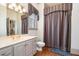 Neutral bathroom featuring double vanity, shower/tub, and colorful accents at 4808 Clubview Ct, Fuquay Varina, NC 27526