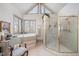 Bright bathroom featuring a large soaking tub, glass enclosed shower, and lots of natural light at 4808 Clubview Ct, Fuquay Varina, NC 27526