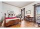 Bedroom boasting wood floors, warm colors, a sitting area, and an abundance of light at 4808 Clubview Ct, Fuquay Varina, NC 27526