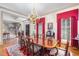 An elegant dining room featuring beautiful hardwood floors, a large table, and an ornate chandelier at 4808 Clubview Ct, Fuquay Varina, NC 27526