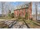 Beautiful exterior elevation of this brick home features mature trees and a manicured lawn at 4808 Clubview Ct, Fuquay Varina, NC 27526