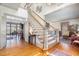 Bright foyer featuring hardwood floors, a staircase, and views into the dining and living areas at 4808 Clubview Ct, Fuquay Varina, NC 27526