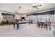 Spacious game room with pool table, dining area, and large windows offering plenty of natural light at 4808 Clubview Ct, Fuquay Varina, NC 27526