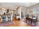 Bright, open kitchen with stainless appliances and granite countertops adjacent to the dining area for effortless entertaining at 4808 Clubview Ct, Fuquay Varina, NC 27526