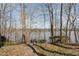 Path leading to a serene lake view surrounded by trees and a dock at 4808 Clubview Ct, Fuquay Varina, NC 27526