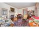 Elegant living room with a fireplace, piano, and antique furniture, offering a warm and inviting atmosphere at 4808 Clubview Ct, Fuquay Varina, NC 27526
