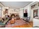 Spacious living room with a fireplace, custom built-ins, hardwood floors, and comfortable seating at 4808 Clubview Ct, Fuquay Varina, NC 27526