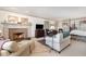 Spacious living room featuring a fireplace, cozy seating, and warm natural light at 4808 Clubview Ct, Fuquay Varina, NC 27526
