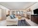 Open-concept living room with fireplace, cozy seating, and lots of natural light at 4808 Clubview Ct, Fuquay Varina, NC 27526