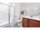 Well-lit bathroom with a shower, wood vanity, and a large mirror at 4963 Highcroft Dr, Cary, NC 27519