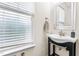 Half bathroom with pedestal sink and dark cabinet, offering a simple and clean design at 4963 Highcroft Dr, Cary, NC 27519