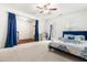 Bright bedroom featuring a ceiling fan, carpet, and a comfortable bed with blue accents at 4963 Highcroft Dr, Cary, NC 27519