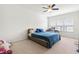 Bright bedroom with carpet, ceiling fan, and large window with neighborhood view, perfect for relaxation at 4963 Highcroft Dr, Cary, NC 27519