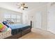 Bright bedroom featuring a ceiling fan, carpet and a large window with neighborhood views at 4963 Highcroft Dr, Cary, NC 27519