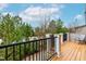 Outdoor deck offers great views, with black railings, a chair, and natural surroundings at 4963 Highcroft Dr, Cary, NC 27519