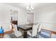 Cozy dining room with modern table, stylish chairs, and hardwood floors next to the kitchen at 4963 Highcroft Dr, Cary, NC 27519