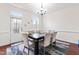 Elegant dining room with modern chandelier, table setting, and access to the outside patio at 4963 Highcroft Dr, Cary, NC 27519