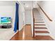 Hallway featuring hardwood floors, stairway, and a blue curtain at 4963 Highcroft Dr, Cary, NC 27519