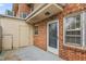 Brick home backyard with a patio, exterior door, and multiple windows providing ample light at 514 Peele St # A, Burlington, NC 27215