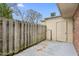 Private backyard area featuring a wooden fence, concrete patio, and convenient exterior door at 514 Peele St # A, Burlington, NC 27215