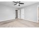 Neutral bedroom with a ceiling fan, carpet, white walls, and several doors at 514 Peele St # A, Burlington, NC 27215