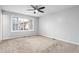 Cozy bedroom with neutral carpet, a ceiling fan, a large window, and light colored walls at 514 Peele St # A, Burlington, NC 27215