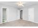 Bedroom with neutral carpet, light colored walls, a ceiling fan, and multiple doorways at 514 Peele St # A, Burlington, NC 27215