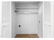 Walk-in closet with white walls and door, wooden flooring, a clothing rod and some shelves at 514 Peele St # A, Burlington, NC 27215