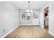 Neutral dining room with light gray walls, wood flooring, and a classic chandelier at 514 Peele St # A, Burlington, NC 27215