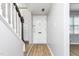 Inviting foyer featuring freshly painted gray walls, light wood flooring, and a staircase with black banister at 514 Peele St # A, Burlington, NC 27215