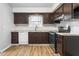 Well-lit kitchen featuring brown cabinets, a stainless steel oven, and a light-colored countertop and flooring at 514 Peele St # A, Burlington, NC 27215