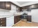 Functional kitchen featuring dark cabinetry, modern stainless steel appliances, and neutral countertops at 514 Peele St # A, Burlington, NC 27215