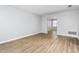 Bright and airy living room featuring light gray walls, wood floors, and an open layout to the dining area at 514 Peele St # A, Burlington, NC 27215