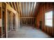 Unfinished attic space featuring wood beams, a window, and potential for customization to suit any need at 6720 Colleen Rd, Rocky Mount, NC 27803