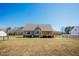 Expansive backyard featuring a large deck, fenced yard, and ample green space for outdoor enjoyment and entertaining at 6720 Colleen Rd, Rocky Mount, NC 27803