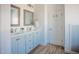 Bathroom featuring double sinks, white countertops, blue cabinets, and wood-look flooring at 6720 Colleen Rd, Rocky Mount, NC 27803