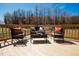 Relaxing outdoor deck with comfortable seating, a coffee table, and serene views, perfect for unwinding and enjoying the outdoors at 6720 Colleen Rd, Rocky Mount, NC 27803