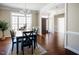 Formal dining area featuring hardwood floors, modern chandelier and a beautiful large window at 6720 Colleen Rd, Rocky Mount, NC 27803