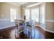 Dining area with wainscotting, trim and large windows letting in plenty of natural light at 6720 Colleen Rd, Rocky Mount, NC 27803