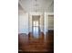 View of the foyer showcasing hardwood floors and contrasting trim with a glimpse of the interior through glass doors at 6720 Colleen Rd, Rocky Mount, NC 27803