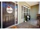 Inviting front porch with welcome decor, a bench, and decorative stone accents, complemented by a window and shutter at 6720 Colleen Rd, Rocky Mount, NC 27803
