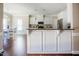 Bright kitchen features granite countertops, white cabinetry, stainless appliances, and a breakfast bar at 6720 Colleen Rd, Rocky Mount, NC 27803