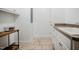 Bright laundry room with tile floor, utility sink, storage, and natural light at 6720 Colleen Rd, Rocky Mount, NC 27803