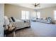 Spacious main bedroom features a seating area, ceiling fan, and an abundance of natural light through multiple windows at 6720 Colleen Rd, Rocky Mount, NC 27803