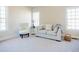 Bright bedroom features a seating area with comfortable furniture, large windows, and neutral decor at 6720 Colleen Rd, Rocky Mount, NC 27803