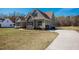 Side view of home featuring neutral siding, garage, and driveway with basketball hoop on expansive lawn at 6720 Colleen Rd, Rocky Mount, NC 27803