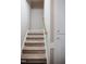 Carpeted staircase features neutral colors and a wooden handrail at 6720 Colleen Rd, Rocky Mount, NC 27803