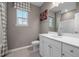 Bathroom with white cabinets, brushed nickel hardware, and a window with natural light at 780 Ben Ledi Ct, Raleigh, NC 27603