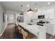 Modern kitchen featuring stainless steel appliances, pendant lighting, and a spacious island with breakfast bar seating at 780 Ben Ledi Ct, Raleigh, NC 27603